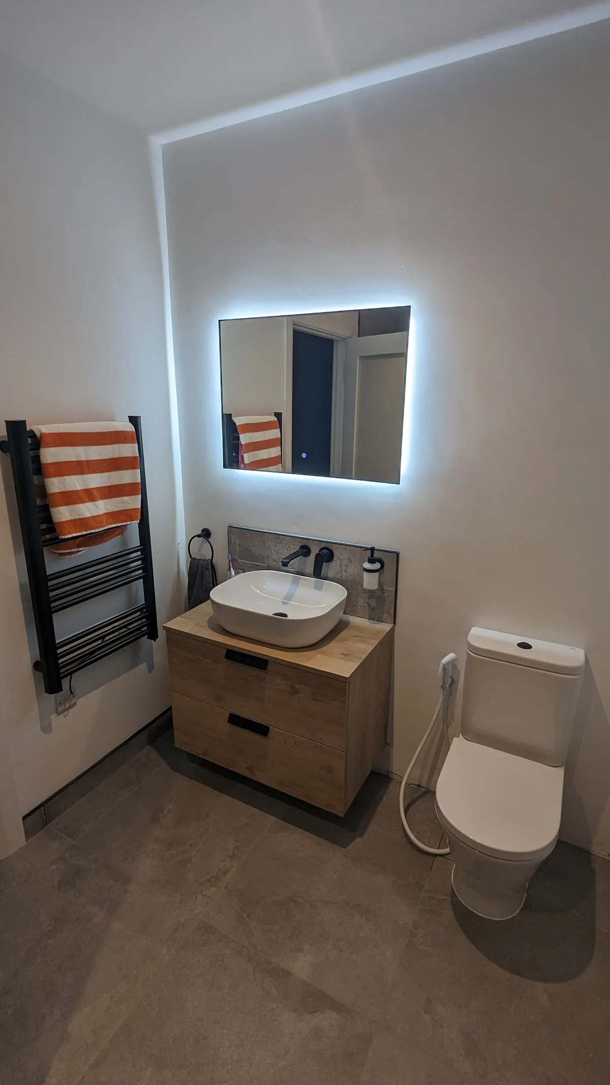 Bathroom with backlit mirror