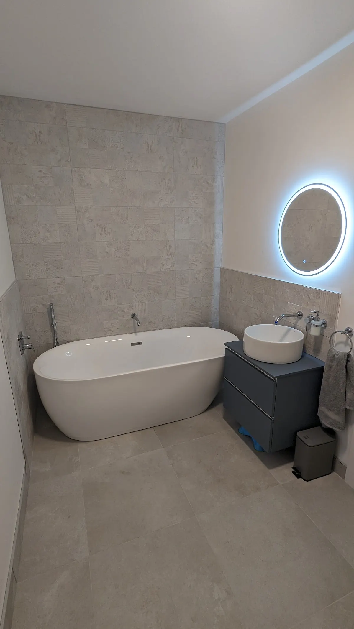 Bathroom renovated by Galway Plumbing Solutions with freestanding bath and backlit mirror